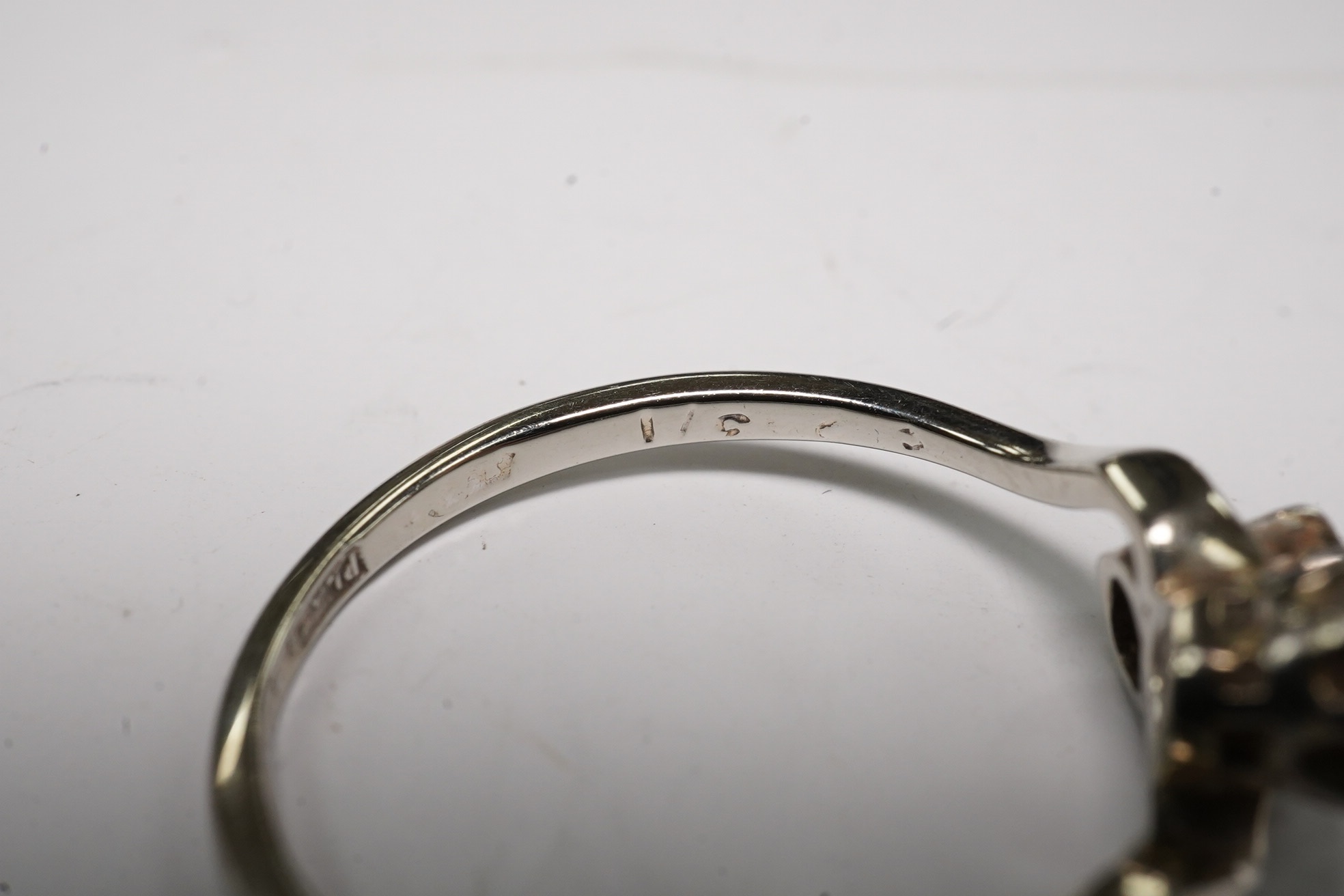 An 18ct, plat and two stone diamond set crossover ring, size O, gross weight 2.3 grams, Condition - fair to good